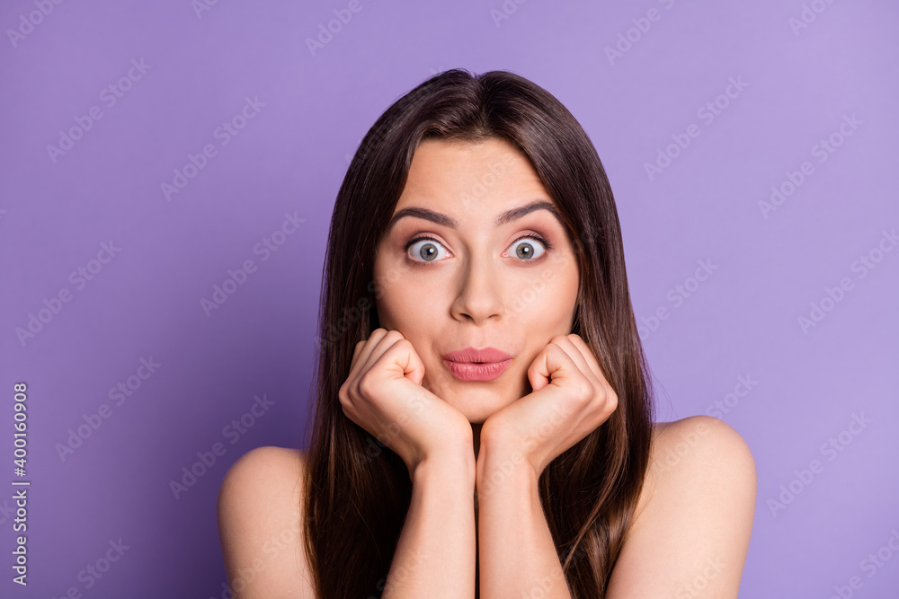 Photo portrait of silly pouting girl holding face chin with two hands isolated on vivid purple colored background Photo portrait of silly pouting girl holding face chin with two hands isolated on vivid purple colored background