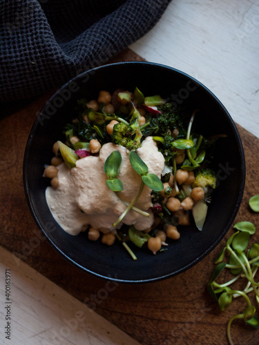 Rustic chickpea fresh green salad in bowl on table.