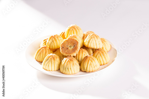 Arabic oriental cookies dates Maamoul in white dish on white background
