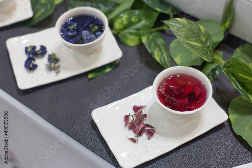 Cup of flower tea on grey background.