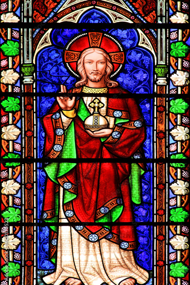 Jesus Christ shown in an image on a medieval stained glass window panel, stock photo 