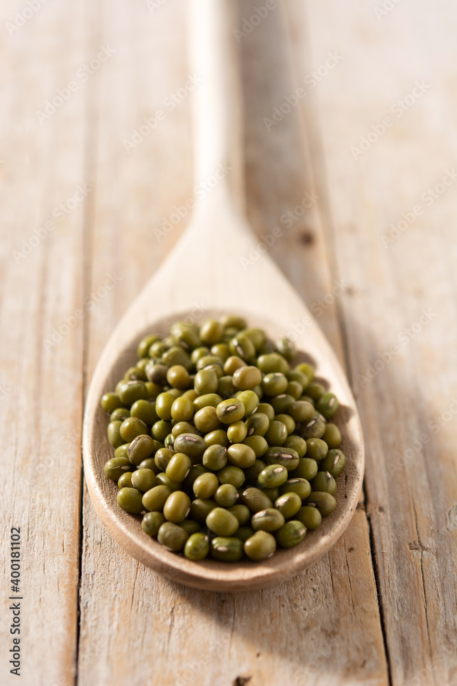 Green soy beans in wooden spoon on wooden table Green soy beans in wooden spoon on wooden table