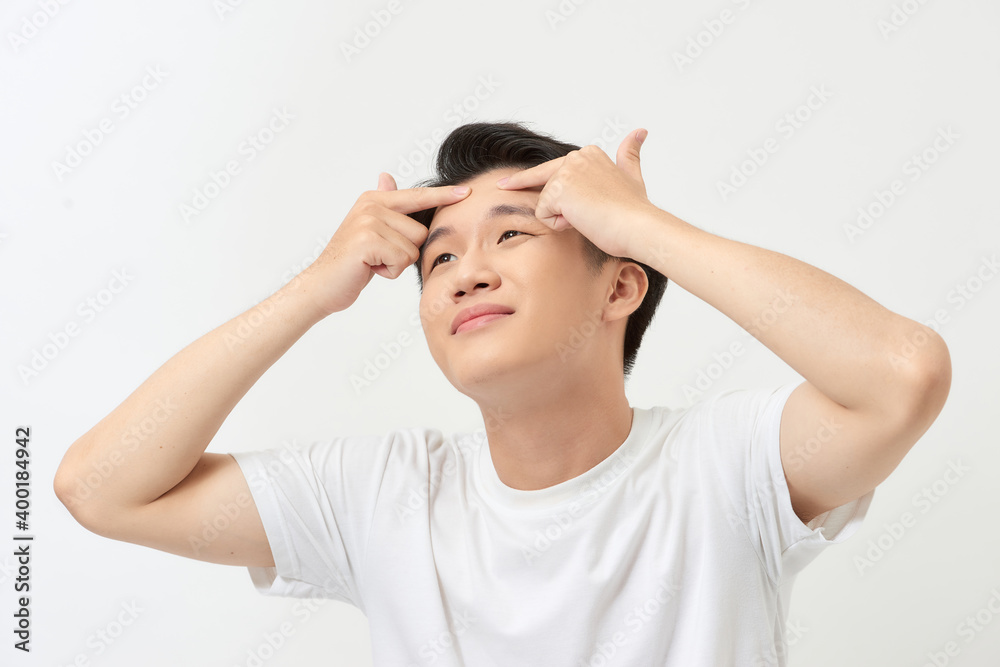 Acne treatment. Acne man squeezing his pimple, removing pimple from him face Acne treatment. Acne man squeezing his pimple, removing pimple from him face