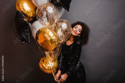 Photography Romantic african girl holding bunch of party balloons