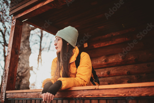 attractive girl who hikers resting in a wooden cottage