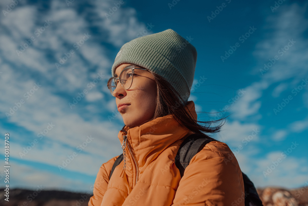 Freedom traveler woman sitting on the top of mountains and enjoy a wonderful nature. Yound girl on peak mountain with perfect view snowy mountains. travel concept Freedom traveler woman sitting on the top of mountains and enjoy a wonderful nature. Yound girl on peak mountain with perfect view snowy mountains. travel concept