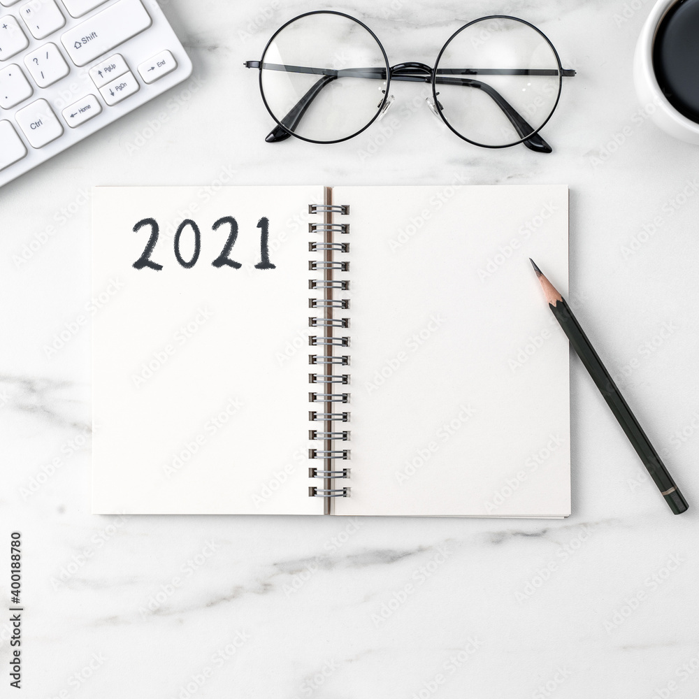 Top view of office table desk 2021 Goal work concept on bright marble white background. Top view of office table desk 2021 Goal work concept on bright marble white background.