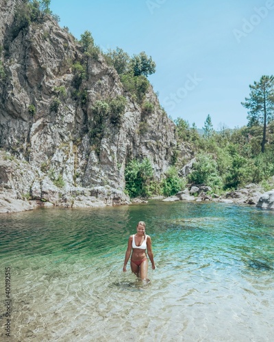 Woman at natural pool in the river in Corsica, France.