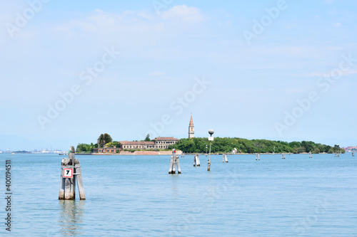Poveglia, a small island located between Venice and Lido in the Venetian Lagoon, Italy, as seen from Malamocco on Lido Island. It was used as a quarantine station in history.
