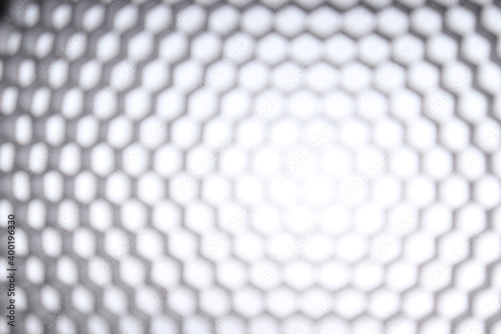 Naklejka premium blurry black honeycomb on white isolated background. diffuser products for photographic light