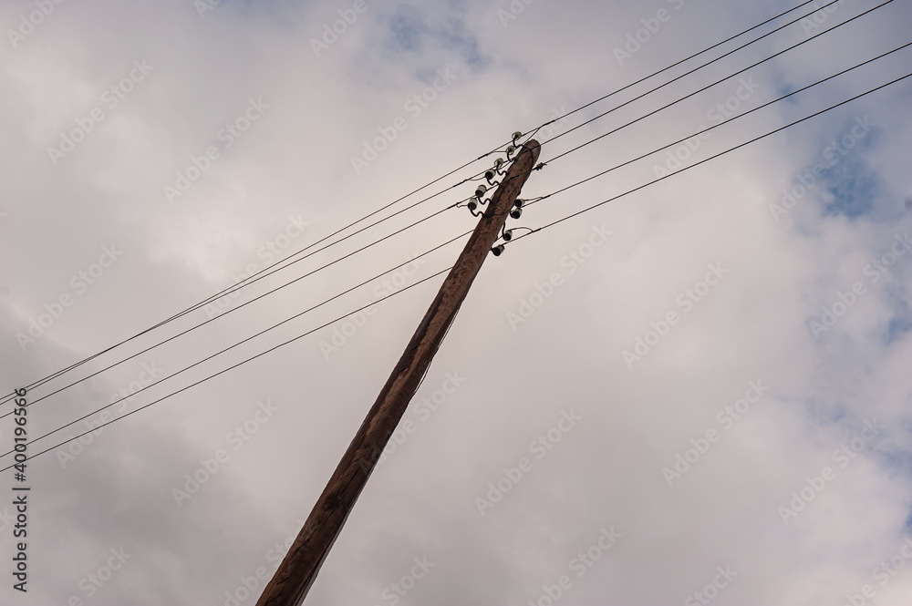 Poles with wires of power lines on the background of the sky.