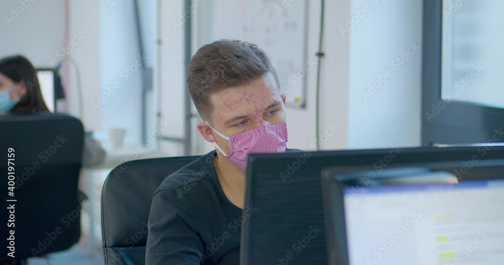 MS DS Office worker in protective face mask using computer MS DS Office worker in protective face mask using computer