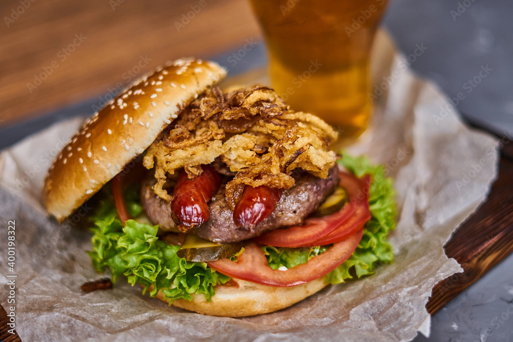  delicious burger with sausages and beer on a wooden board
