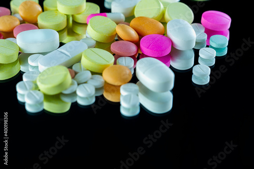 Lot of pharmaceutical pills medicine from above in black background