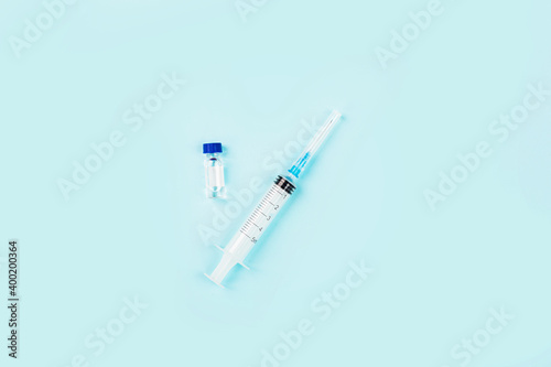 Flat lay of coronavirus covid-19 vaccine with syringe, face mask. Mockup with copy space, top view, overhead