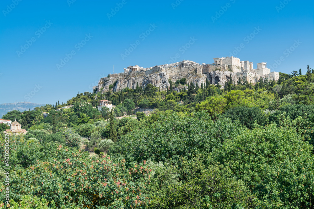 Ruins of Acropolis with  Parthenon, Erechtheum, Beule Gate and Temple of Athena in the city center with green trees in summer, view from the Temple of Hephaestus (Hephaestion)