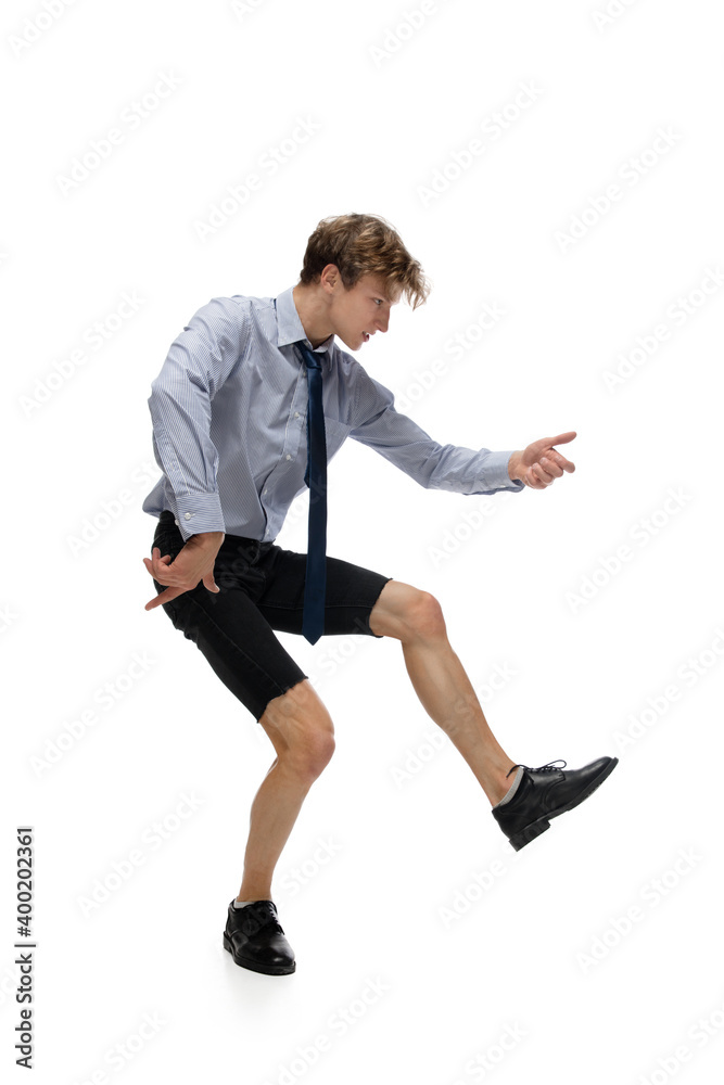 Dance. Happy young man dancing in casual clothes or suit, remaking legendary moves and dances of celebrity from culture history. Isolated on white. Action, motion, fame concept. Creative occupation.