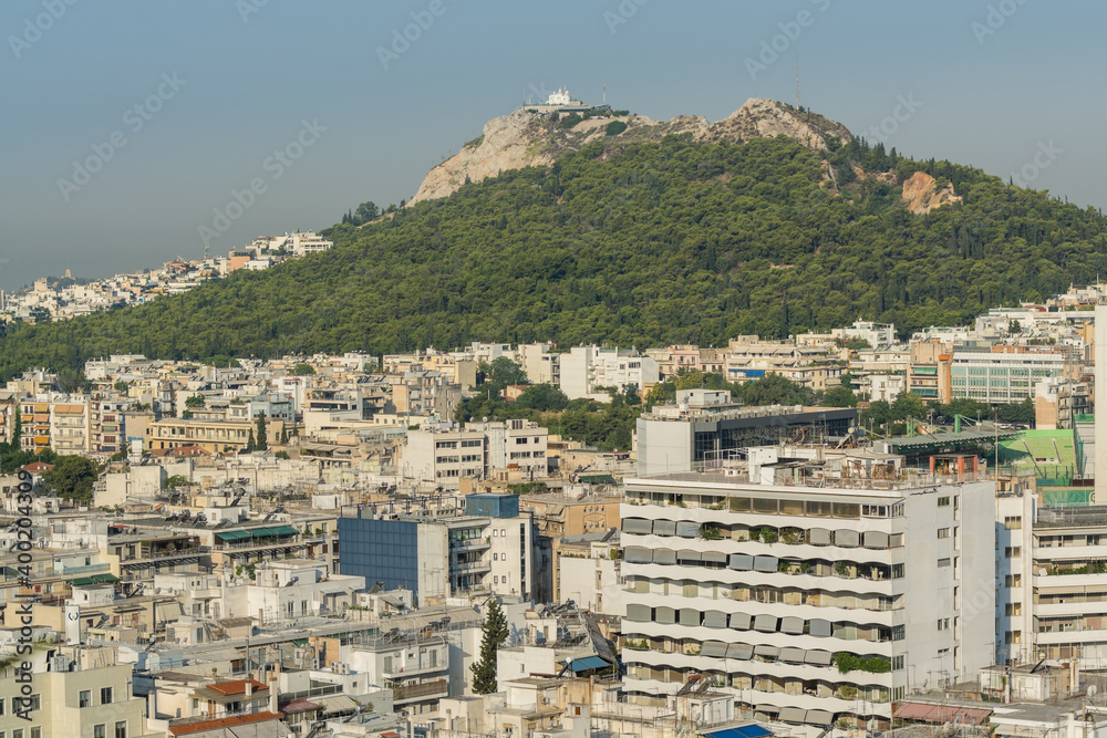 Aerial view of cityscape with crowded buildings of Athens from a top of hotel in a sunny day in Greece