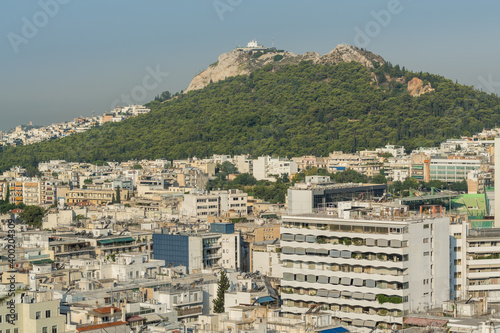 Fototapeta Naklejka Na Ścianę i Meble -  Aerial view of cityscape with crowded buildings of Athens from a top of hotel in a sunny day in Greece
