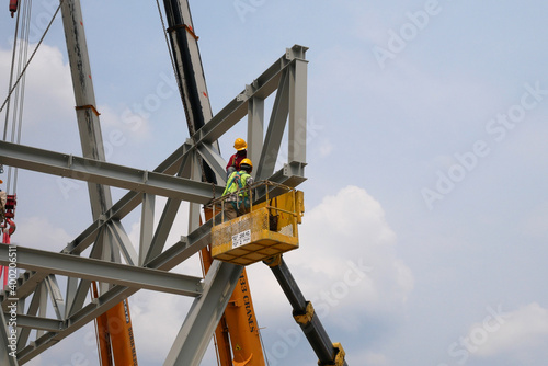 Wallpaper Mural MALACCA, MALAYSIA -MARCH 12, 2020: Construction workers working at height at the construction site. They are supplied with harnesses and other safety equipment to prevent them from having an accident. Torontodigital.ca