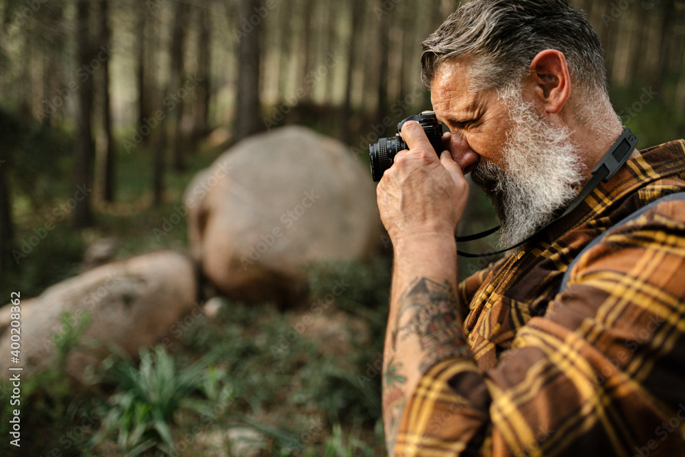 Close up of caucasian senior man taking photo with camera Close up of caucasian senior man taking photo with camera