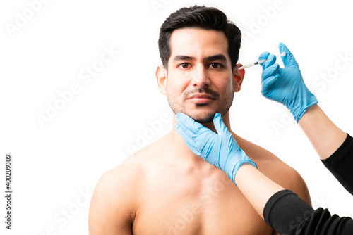 Young man going through a facelift procedure