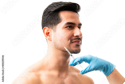 Doctor giving botox injection to a man