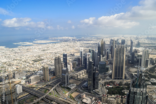 Fotografia, Obraz View of Dubai from the top of Burj Khalifa. The sky is blue.