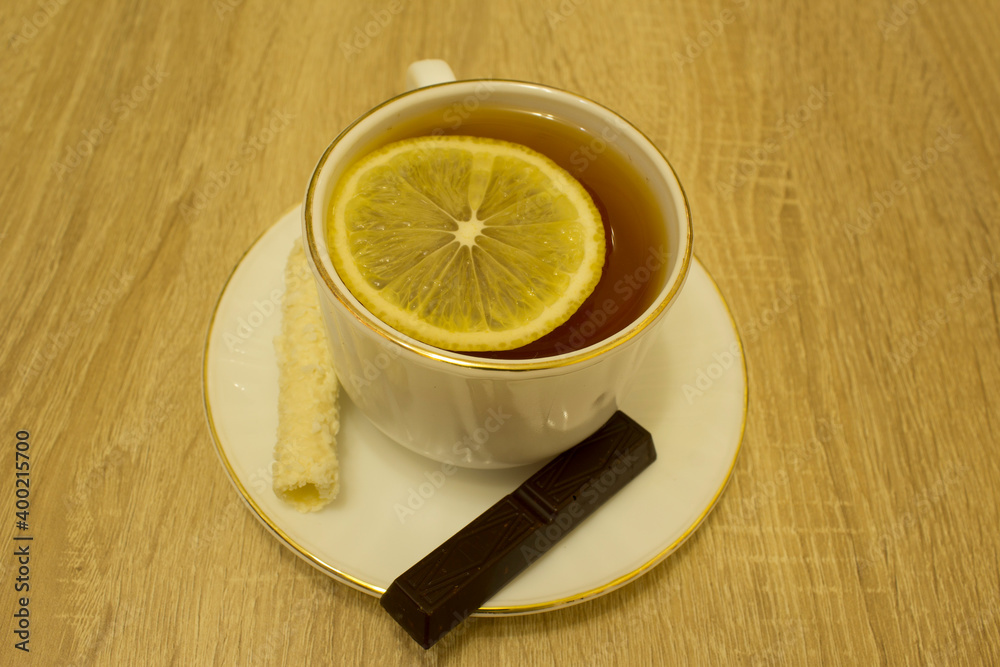 tea in a mug with lemon and sweets tea in a mug with lemon and sweets
