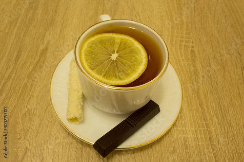 tea in a mug with lemon and sweets 