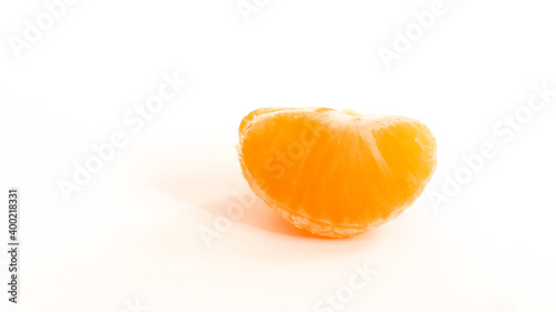 Tangerine slice on white background.