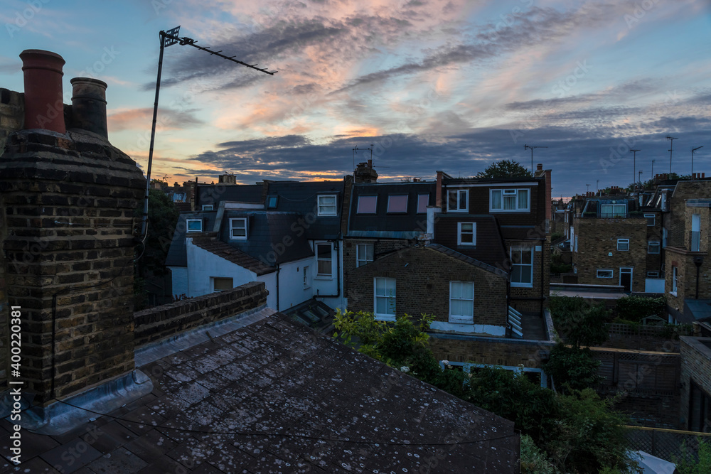 Sunrise over the roofs of suburban London.