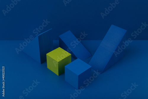 Abstract duotone composition with geometric figures on dark blue background