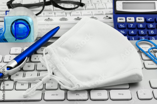 Face  mask and office with pc keyboard photo