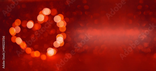 Valentine's Day background, bokeh red heart. Red glitter sparkle confetti. Invitation to the Happy birthday party.
