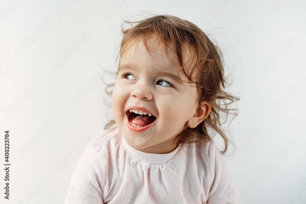 a child on a white background shows his tongue in his mouth, emotions. a child on a white background shows his tongue in his mouth, emotions.
