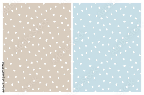 Simple Irregular Geometric Seamless Vector Patterns Set. White Freehand Brush Spots Isolalet on a Warm Gray and Pastel BlueBackground. Abstract Doodle Print ideal for Fabric, Textile.