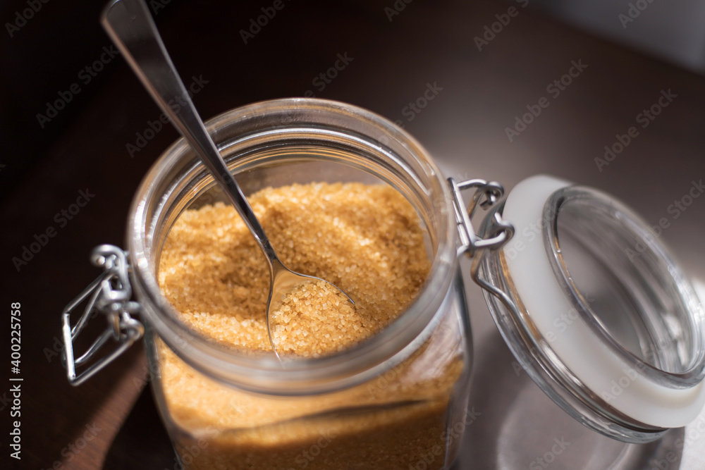 Transparent glass jar with brown sugar cane on a black background Transparent glass jar with brown sugar cane on a black background
