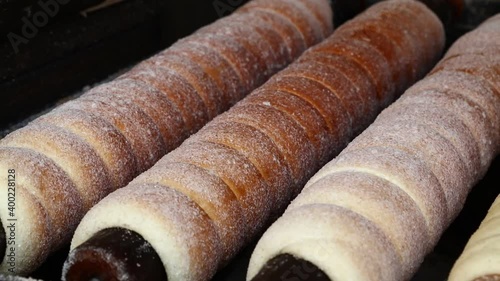 Close up chimney cake baking and rolling photo