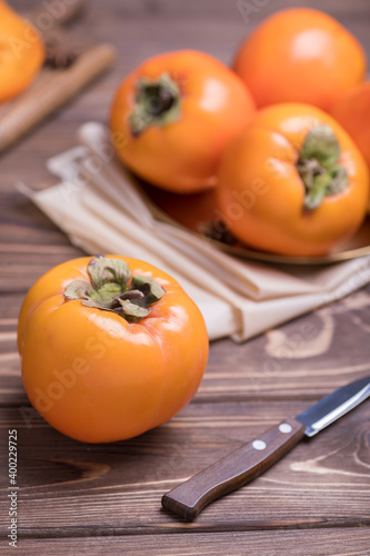 Delicious fresh persimmon fruit on wooden table.