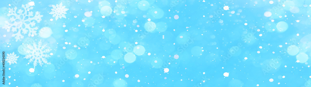 snowflakes and ice crystals isolated on blue sky - winter background panorama banner long	