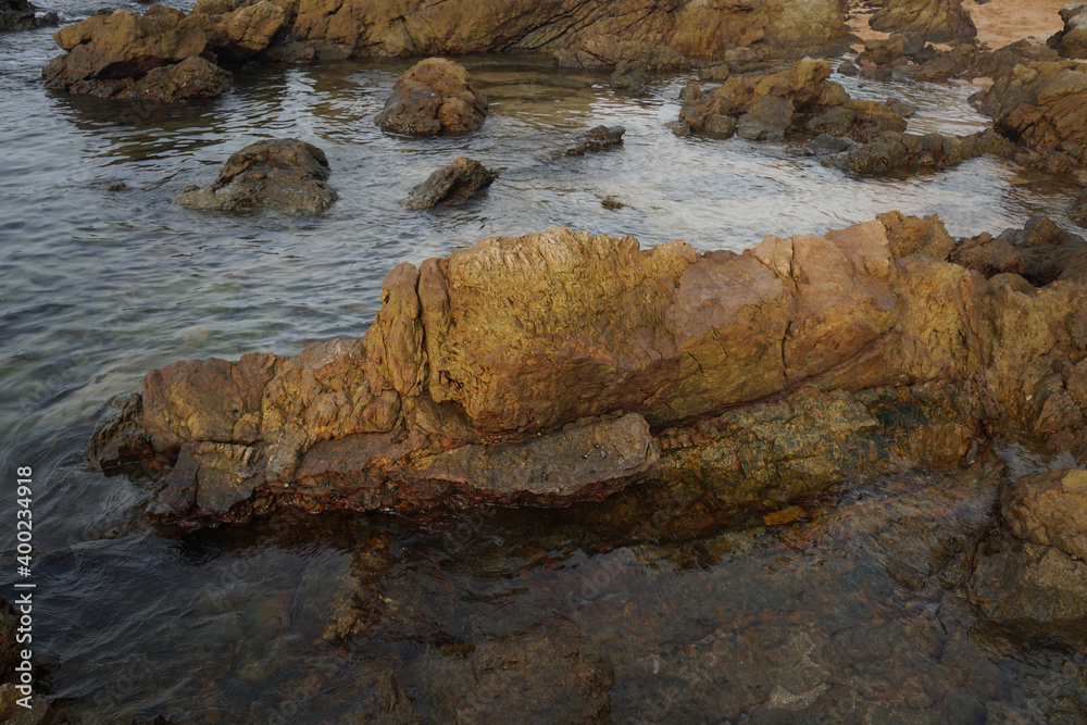 unusual sandstone emerging from the sea. reef rocks on natural background.