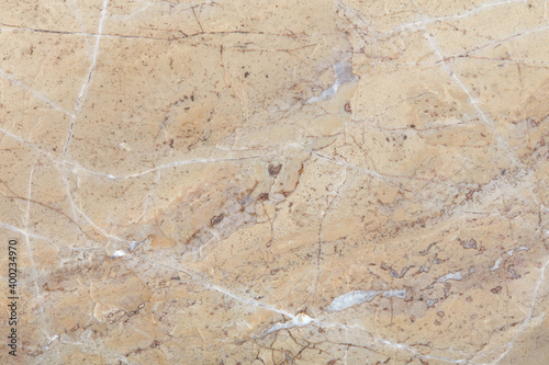 Beige stone texture background with white veins and scratches