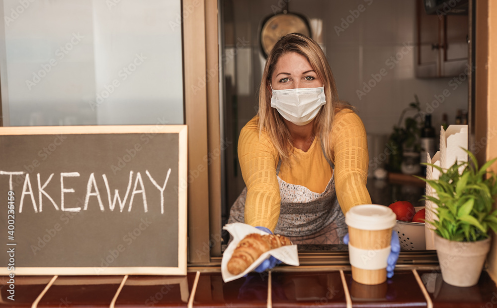 Young woman at work in take away bar with croissant and coffe cup while wearing surgical face maska for coronavirus - obrazy, fototapety, plakaty 