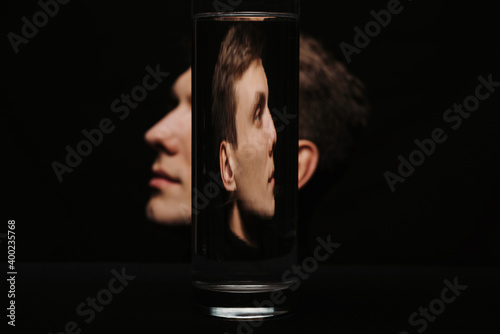 portrait of a man in profile through a container of water