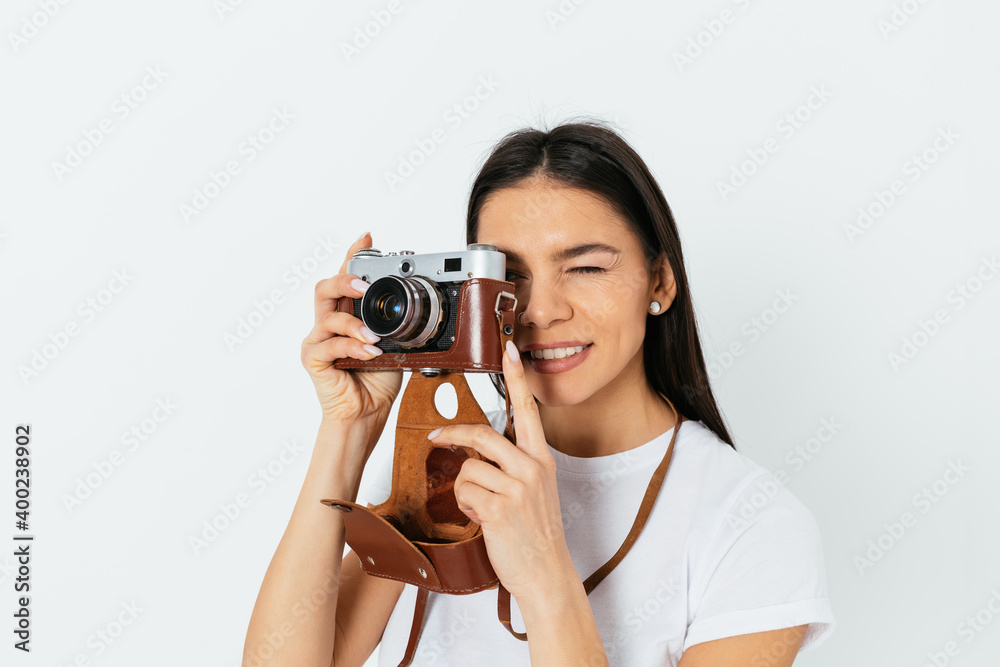 Young woman takes pictures on a retro camera Young woman takes pictures on a retro camera