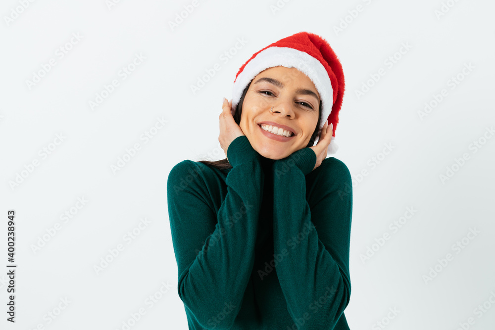 Smiling brunette woman in santa hat