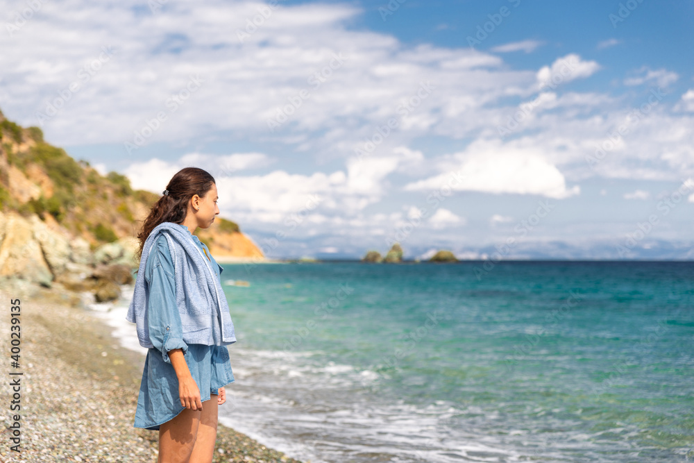 Young woman tourist watching sea landscape, Livadi beach Greece Young woman tourist watching sea landscape, Livadi beach Greece