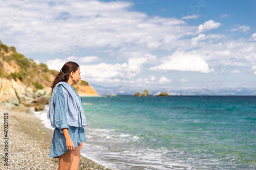 Young woman tourist watching sea landscape, Livadi beach Greece