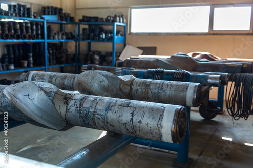 Machined parts and drill components in a bright industrial workspace photo